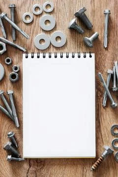 Construction tools. The screws, nuts and bolts arranged around blank spiral b Stock Photos