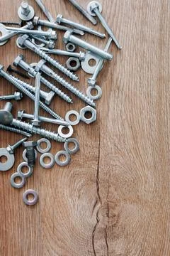 Construction tools. The screws, nuts and bolts on wooden background. Repair,  Stock Photos