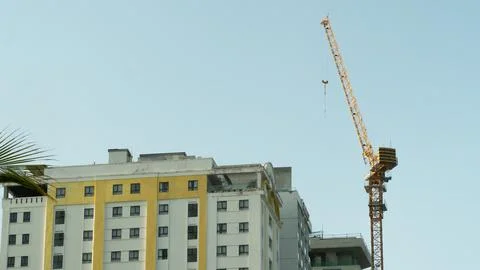 Construction tower crane on the background of a multi-storey building under.. Stock Photos
