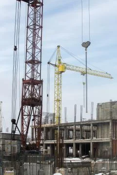 Construction tower crane on a building construction Stock Photos