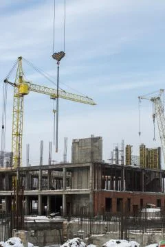 Construction tower crane on a building construction Stock Photos