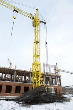 Construction tower crane on a building construction Stock Photos