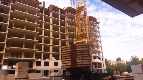 A construction tower crane at a construction site. An industrial tower crane Видео 345832155
