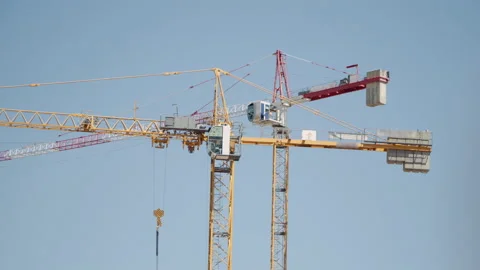 Construction tower crane isolated, blue sky, medium static low angle shot. Stock Footage 132301136