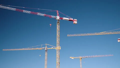 Construction tower crane isolated, blue sky, wide static low angle shot. Stock Footage 132304125