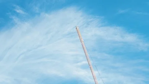 Construction Tower Crane with Lifting Hook Against Blue Sky Stock Footage 348254621
