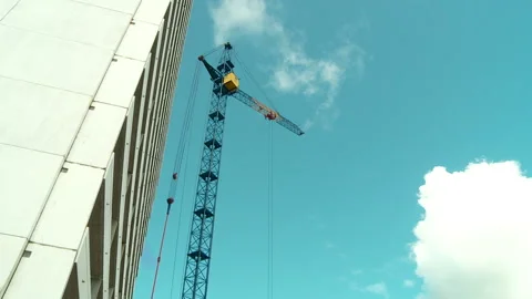 Construction tower crane works on the construction of a residential building Stock Footage 150674121