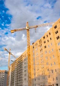 Construction tower cranes are on the construction site Stock Photos