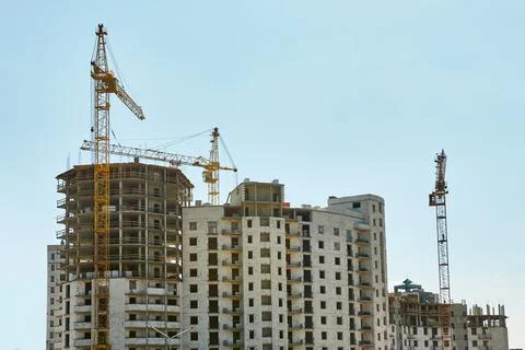 Construction tower cranes on a large building. Stockfoto's