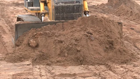 Construction tractor with specialized dozer blade pushing 動画素材 330351122