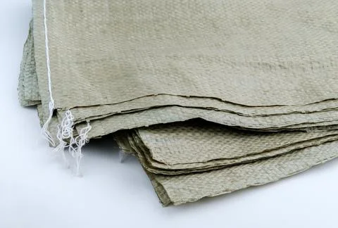 Construction trash bags on a gray background. Stock Photos