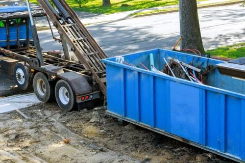 Construction trash loading the garbage dumpsters can waste construction trash Stock Photos