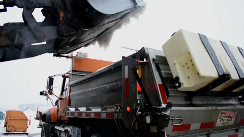 Construction Truck, Front End Loader Dumping Salt Into Snow Plow Stock Footage 148704033