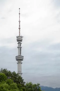 Construction of a TV tower among trees and sky Stock Photos