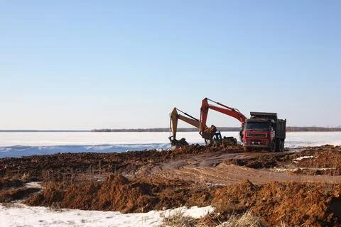 Construction - Two excavator behind dump truck work Foto stock