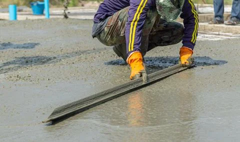 Construction under the building with mason plastering concrete to a cement . Stock Photos