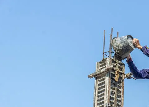 Construction under the building with mason plastering concrete to a cement. Stock Photos