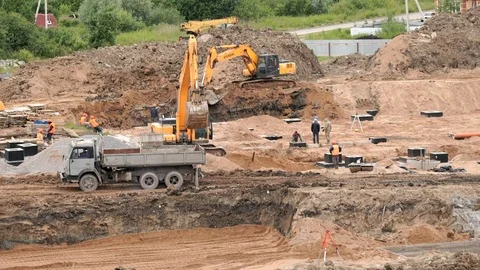Construction vehicles and builders outdoors Stock Footage