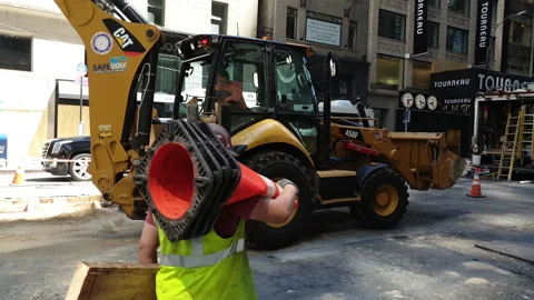 Construction Vehicles and Construction Crews work on tight Manhattan Streets Stock Footage 133447809