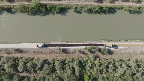 Construction Vehicles Building New Bicycle Path Beside Waterway Stock Footage 337998970