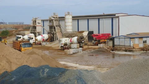 The construction vehicles in the concrete batch plant are busy working to make 스톡 동영상 130885411