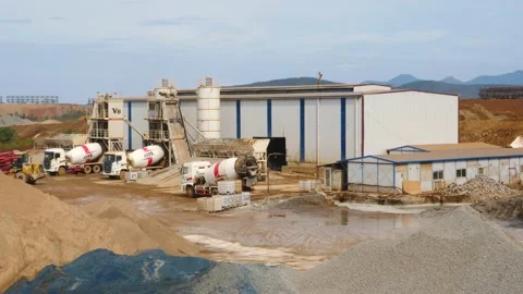 The construction vehicles in the concrete batch plant are busy working to make 스톡 동영상 130885911