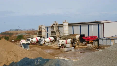 The construction vehicles in the concrete batch plant are busy working to make 스톡 동영상 130885930