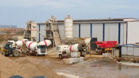 The construction vehicles in the concrete batch plant are busy working to make 스톡 동영상 130885947