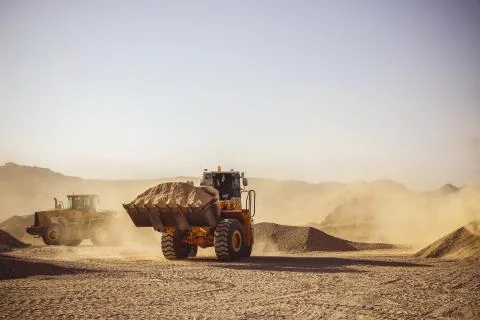 Construction Vehicles in Desert working Stock-Fotos