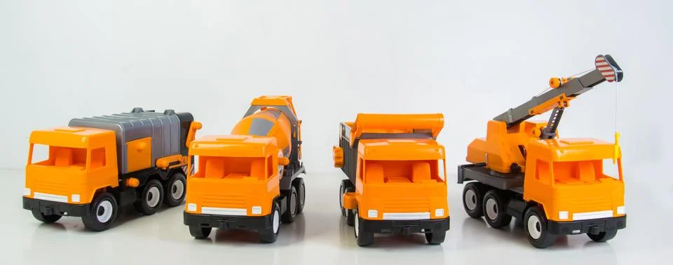 Construction vehicles lined up in a row. Multi-colored children's toys plas.. 写真素材