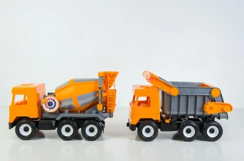 Construction vehicles lined up in a row. Multi-colored children's toys plas.. 写真素材