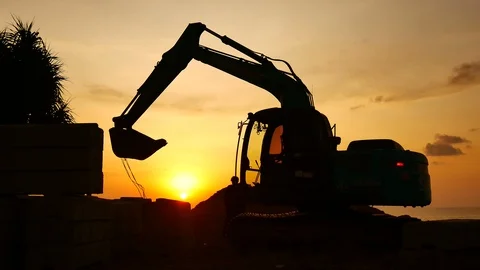 Construction Video At construction site close up The silhouette excavator is  Stockbeeldmateriaal 99130198