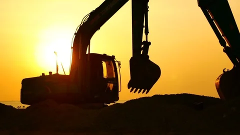 Construction Video At construction site The silhouette excavator is digging g Stockbeeldmateriaal 99129024