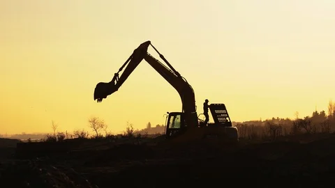 Construction Video At construction site The silhouette excavator is digging Stock Footage 105147782