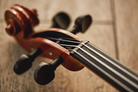 Construction of violin. Top view of the violin neck lying on wooden background Stock Photos