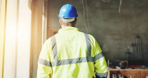 Construction, walking and man with back on site for building inspection Fotos de archivo
