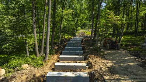 Construction of a Walking Path With Concrete Slabs in a Wooded Area Near a Ro Stock Photos