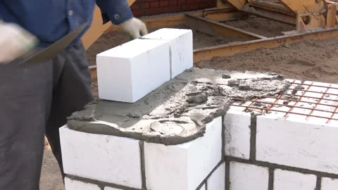 Construction of the wall of white brick. Video stock 313443768