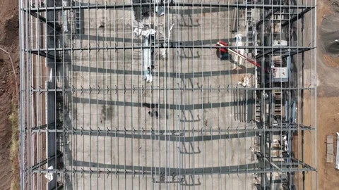 Construction of warehouse using metal foundation. half installed iron sheet.. Stock Footage 284708035