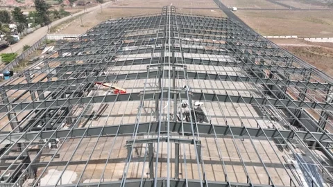 Construction of warehouse using metal frame materials. close up aerial dron.. Stock Footage 284707760
