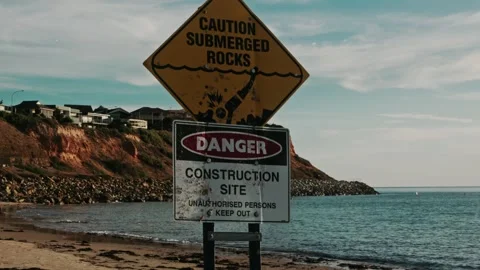 Construction Warning Caution Signs at Beach – Sunset 4K Cinematic (24fps) Stock Footage 303731410