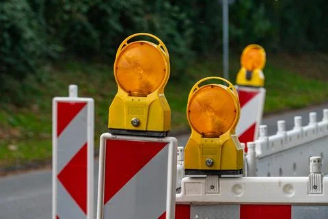 Construction warning lights marking a closed road section Stock Photos