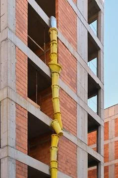 Construction waste chute on building facade macro photo Stock Photos