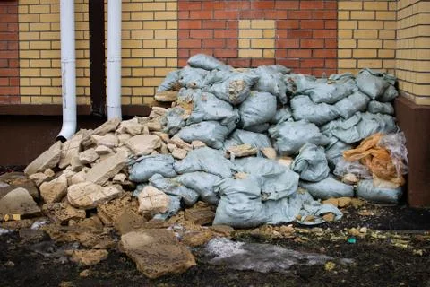 Construction waste under the windows of the house on the street. Stock Photos