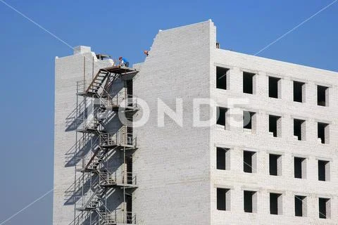 Construction of a white brick residential building Stock Photos