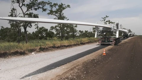Construction of wind power plants. Heavy vehicles with blades for wind turbines. Stock Footage 113108244
