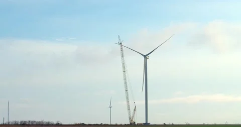 Construction of a wind turbine in the field with a crane, innovation, 4k Stock Footage 158687265
