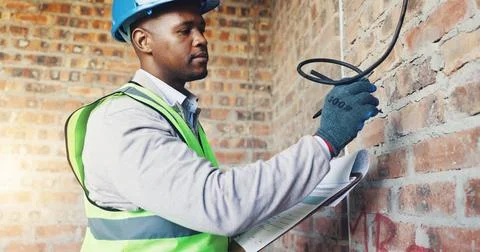 Construction, wire or black man on site with clipboard, electrical review o.. Stock Photos