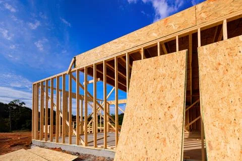 Construction of wooden house in with visible framework beams plywood panels in Stock Photos