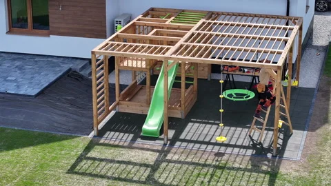 Construction of a Wooden Playground Structure With a Slide and Climbing Elements Stock Footage 308538846